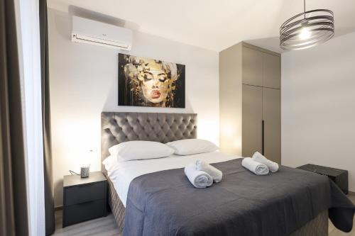 a bedroom with a bed with two towels on it at Classy apartments in city centar in Zadar