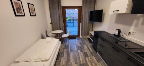 a room with a bed and a desk and a table at Pensjonat Senya in Niechorze