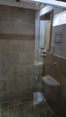a bathroom with a glass shower with a toilet at Hotel Marrokos Aeropuerto José María Córdova in Rionegro