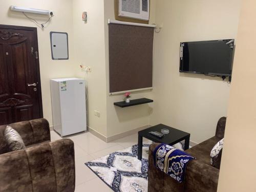 a living room with two couches and a tv at شقق ضيافه خاصه 5391 in Yanbu
