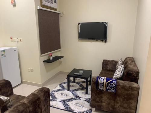 a living room with two couches and a flat screen tv at شقق ضيافه خاصه 5391 in Yanbu
