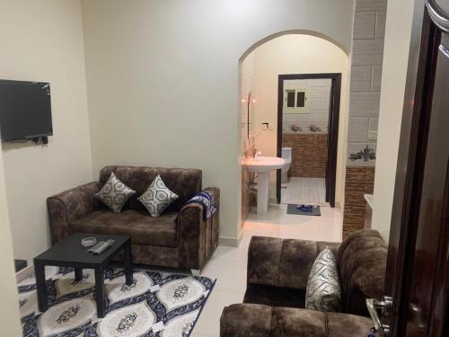a living room with a couch and a chair at شقق ضيافه خاصه 5391 in Yanbu