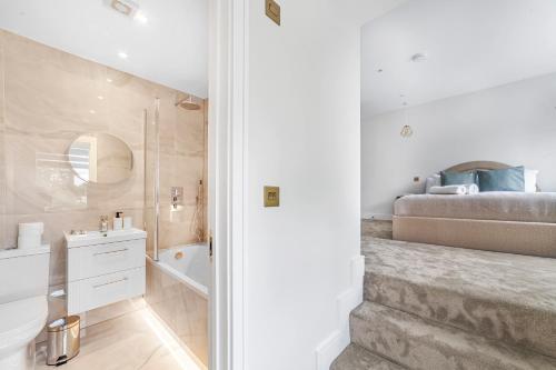 a white bathroom with a bed and a sink at Arte Stays - Serviced Apartments for Leisure and Business - Private Parking - 12 minutes walking from Wembley Stadium in London