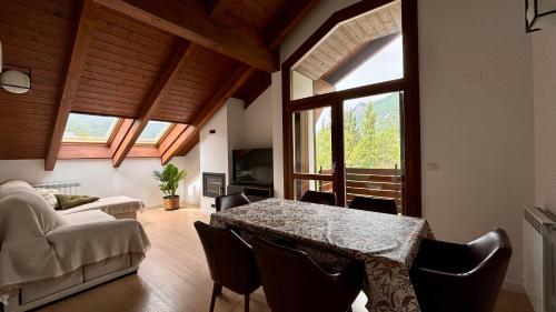 a living room with a table and a couch at BPIRINEOS-Pico Cerler in Benasque