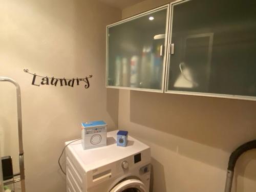 a laundry room with a washing machine and a cabinet at La Canonica di Soglio in Camerano Casasco