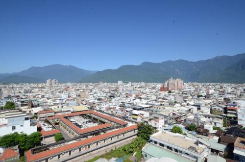 an aerial view of a city with mountains in the background at Shiny Ocean Hotel in Hualien City