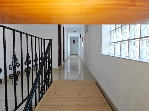 a hallway with a staircase and a window at Casa Izbuc in Izbuc