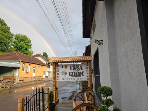 a sign for a cafe with a rainbow in the background at Casa Izbuc in Izbuc