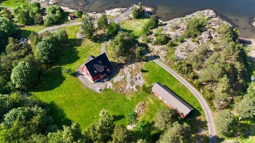 an aerial view of a house on a hill with a farm at Beach villa 4 soverom in Nord Måkerøy