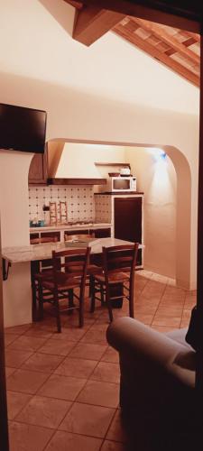 a kitchen with a table and chairs in a room at La Torre wine resort in Montecarlo