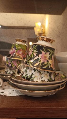 a stack of plates and a vase on a table at Arca Hotel in Pienza