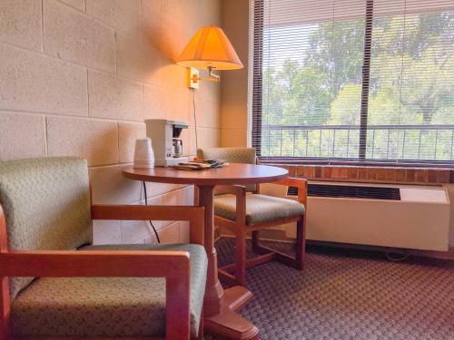 a room with a table and chairs and a window at Hillside Lodge in Lake Junaluska