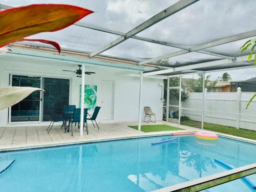 a swimming pool with a pergola next to a house at Sunrise Family Oasis Pool Lake Canal Views in Sunrise