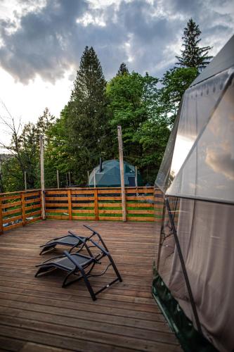 a wooden deck with a wooden fence and a sculpture at BUNNY GLAMP in Korbielów
