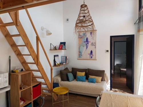 un salon avec un canapé et un escalier dans l'établissement Notre petite maison, à La Rochelle