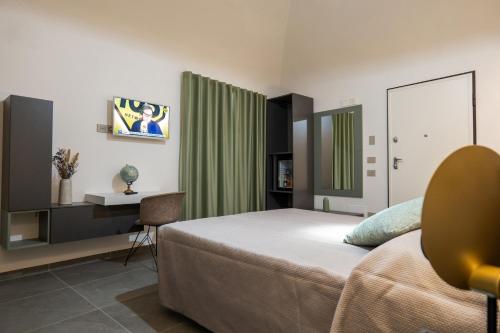 a bedroom with a bed and a desk and a table at Il Castelluccio Scafati in Scafati