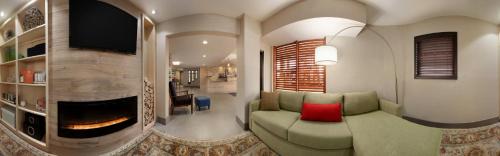a living room with a couch and a red pillow at Country Inn & Suites by Radisson, Bakersfield, CA in Bakersfield