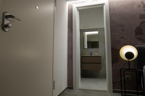 a hallway with a door leading to a bathroom with a mirror at Il Castelluccio Scafati in Scafati