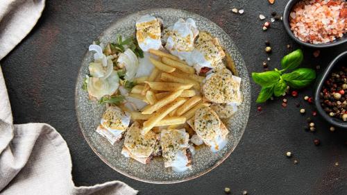 a plate of food with a sandwich and french fries at Lagom Hotel in Edirne