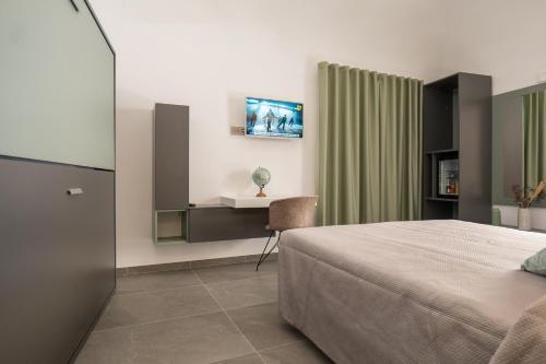a bedroom with a bed and a desk and a chair at Il Castelluccio Scafati in Scafati