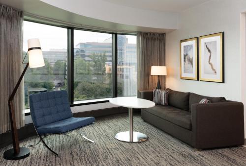 a living room with a couch and a chair at Hilton Fairfax, Va in Fairfax