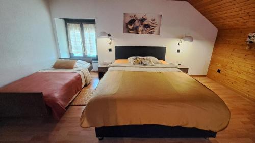 a bedroom with two beds in a room at Hôtel La Fontaine in Saint-Imier