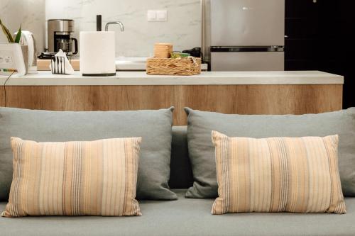 two pillows sitting on a couch in a kitchen at The Clock House in Veria