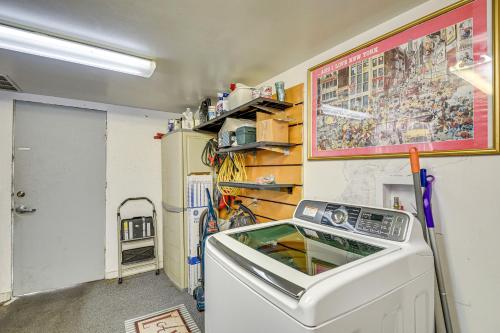 a laundry room with a washing machine and a wall at Walk to Historic Dtwn Sanford Home with Gas Grill! in Sanford