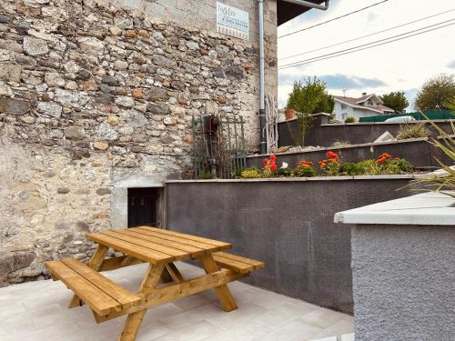 a wooden picnic table sitting on a patio at Chez Gaston - Entrelacs in Pouilly