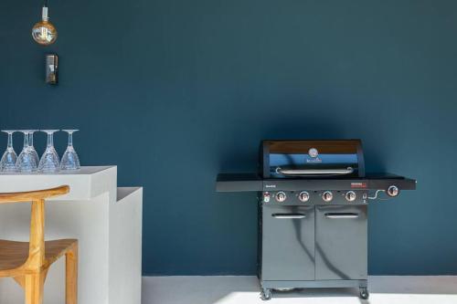 a kitchen with a stove and a counter with aperature at Elegant Ocean View Villa Serena in Cóbano