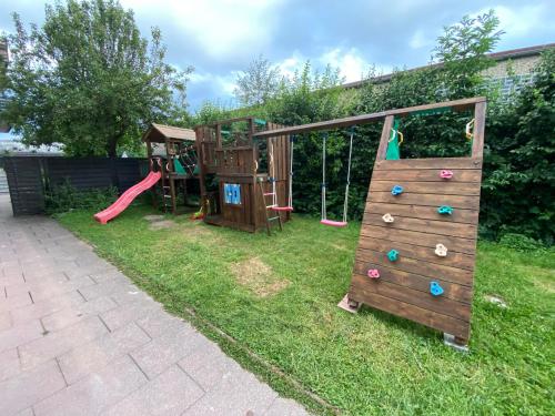 a playground with two play equipment in a yard at Loft Neunkirchen NY in Neunkirchen am Brand