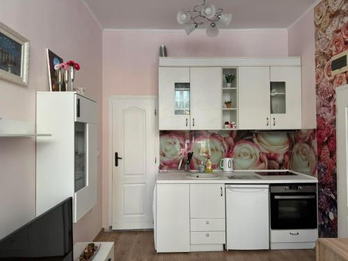 a kitchen with white cabinets and a sink at Roses in Sofia