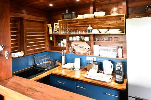 a kitchen with wooden cabinets and a counter top at Domaine de Ti Coin in Rivière-Salée
