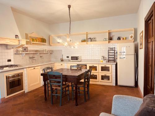 a kitchen with a table and chairs and a refrigerator at La Torre wine resort in Montecarlo