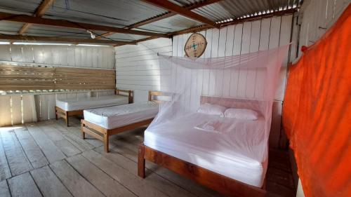 a bedroom with two beds in a room at Ahuma Hospedaje in San Martín