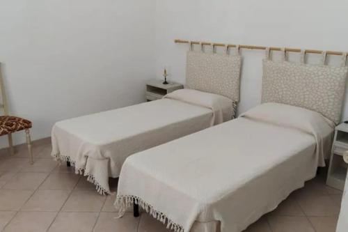 Postel nebo postele na pokoji v ubytování Casa Indipendente nel Cuore della Costa Smeralda Comfort per Famiglie e Gruppi