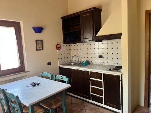 a small kitchen with a table and a sink at La Torre wine resort in Montecarlo
