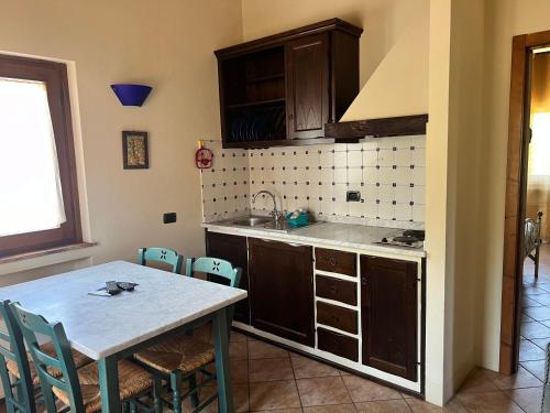 a kitchen with a table and a sink and a stove at La Torre wine resort in Montecarlo