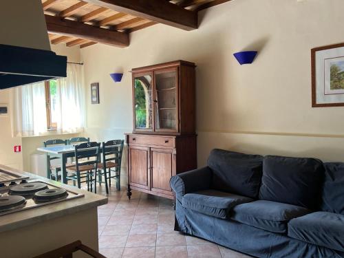 a living room with a blue couch and a table at La Torre wine resort in Montecarlo
