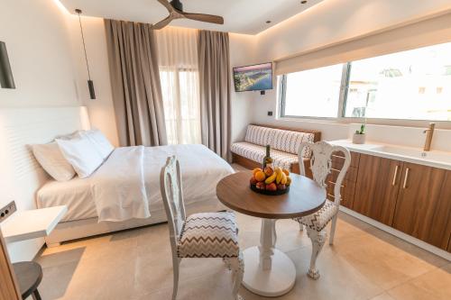 a bedroom with a bed and a table with a bowl of fruit at Granny's House in Kos Town