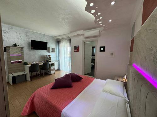 a bedroom with a large bed with a red blanket at B&B Palazzo del Toro in Montesilvano