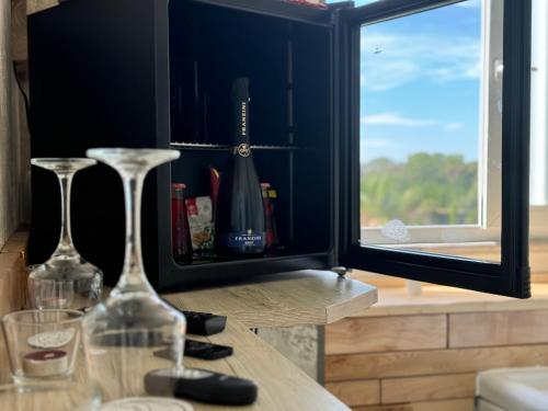 two wine glasses sitting on a table in front of a window at B&B Palazzo del Toro in Montesilvano