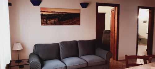 a living room with a couch and a painting on the wall at La Torre wine resort in Montecarlo