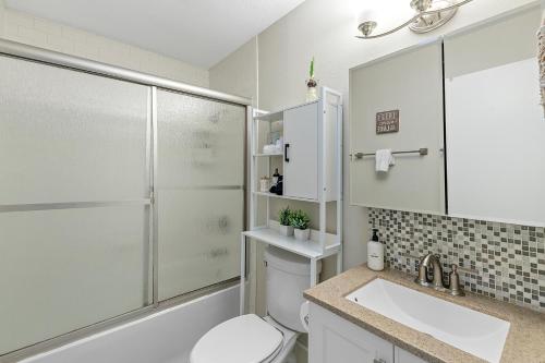 a bathroom with a shower and a toilet and a sink at The Hickory House with Firepit- Boat Ramp Access to Cedar Creek Lake in Tool