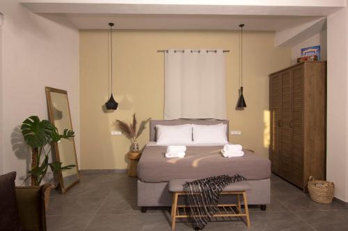 a bedroom with a bed with two towels on it at Lithorama Residence Mani - First Floor in Koúmani