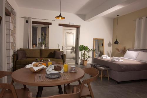 a living room with a couch and a table at Lithorama Residence Mani - First Floor in Koúmani