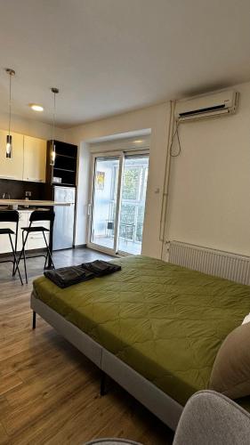 a bedroom with a large green bed in a room at River Apartment in Novi Sad