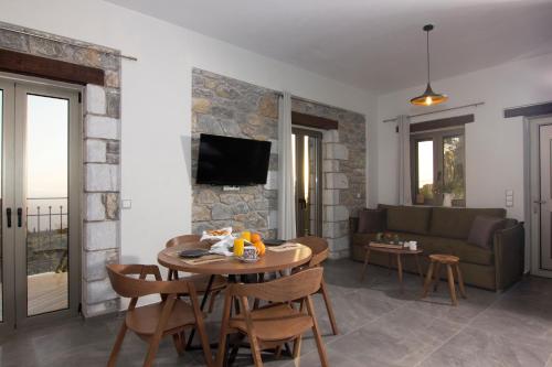 a living room with a table and a couch at Lithorama Residence Mani - First Floor in Koúmani