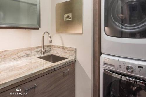 a kitchen with a sink and a microwave at Park Haus on Main Street in Historic Old Town Hosted by Nestique in Park City