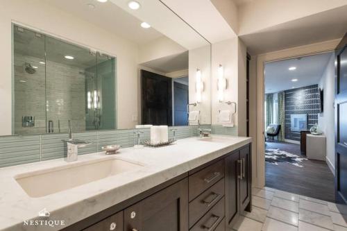 a bathroom with a large sink and a large mirror at Park Haus on Main Street in Historic Old Town Hosted by Nestique in Park City